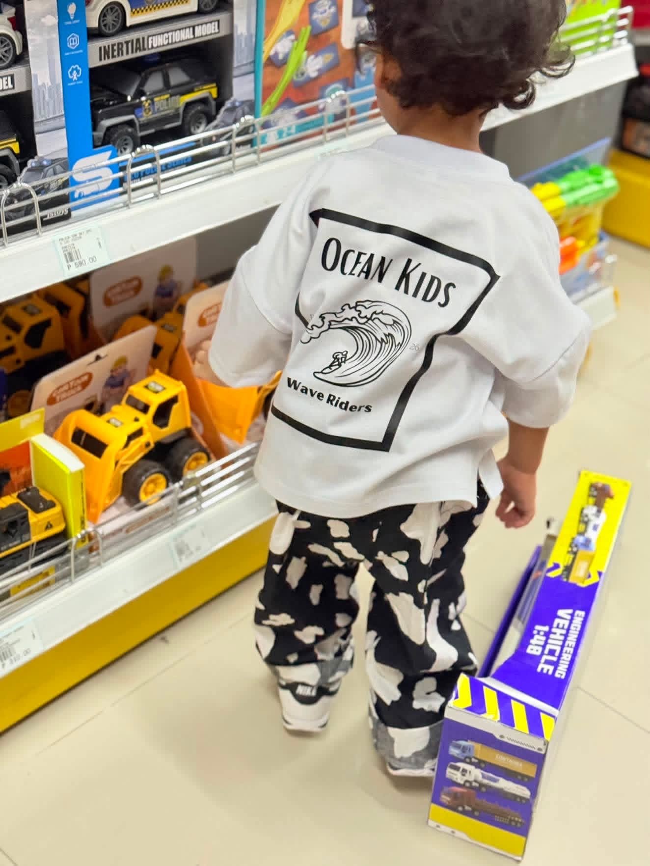 Child exploring in Wave Riders Tee