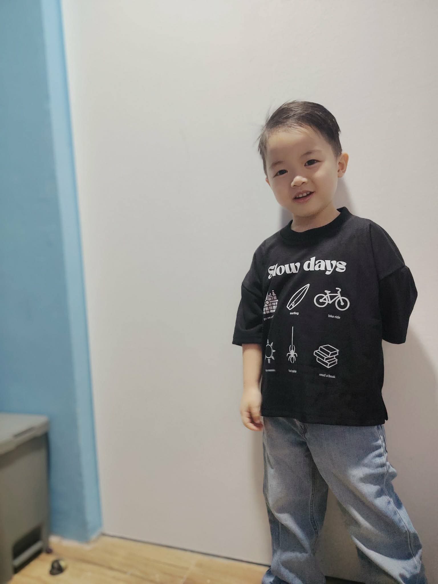 Child in Slow Days Tee at home