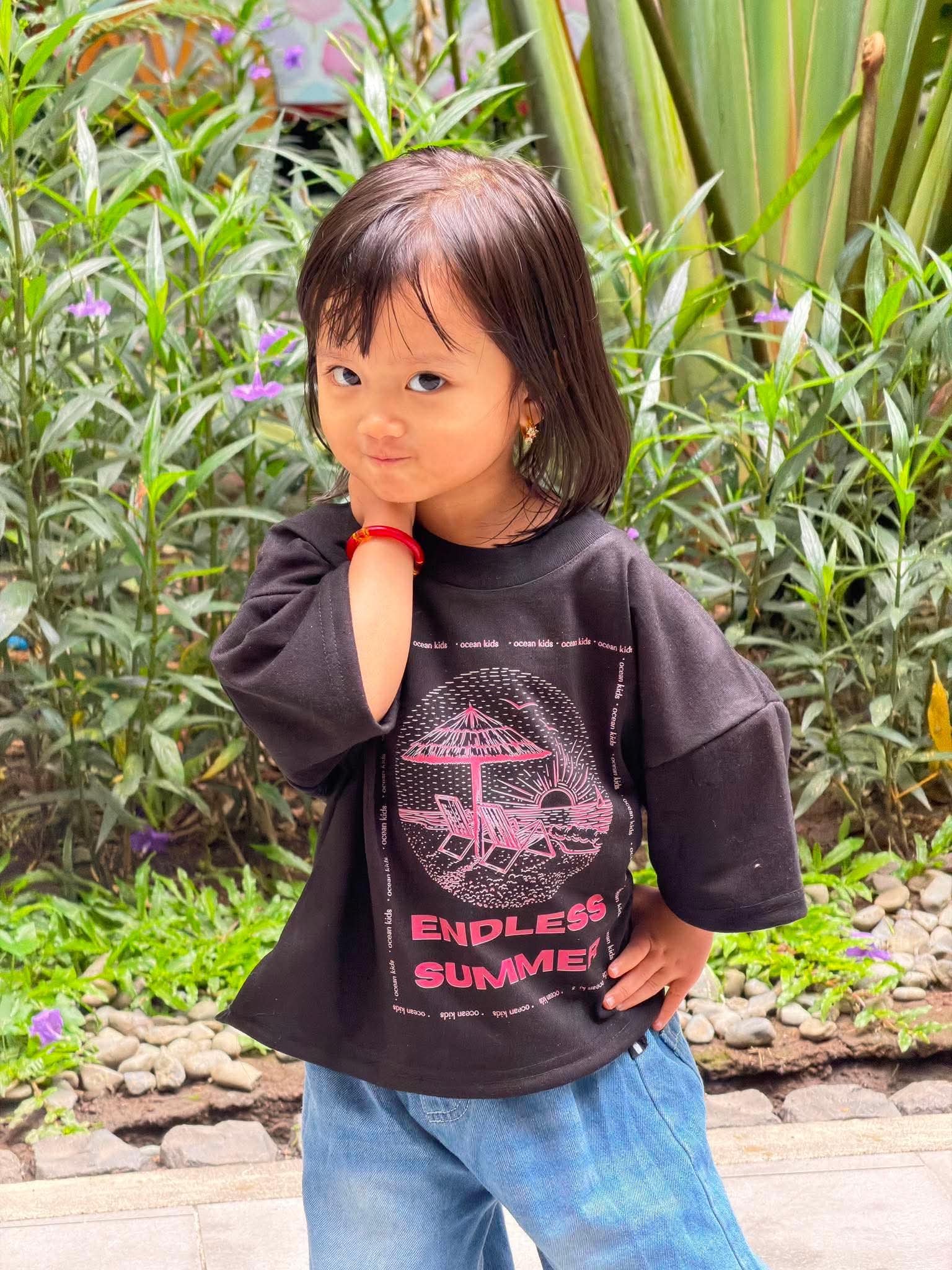 Ocean Kids model in Endless Summer Tee outdoors
