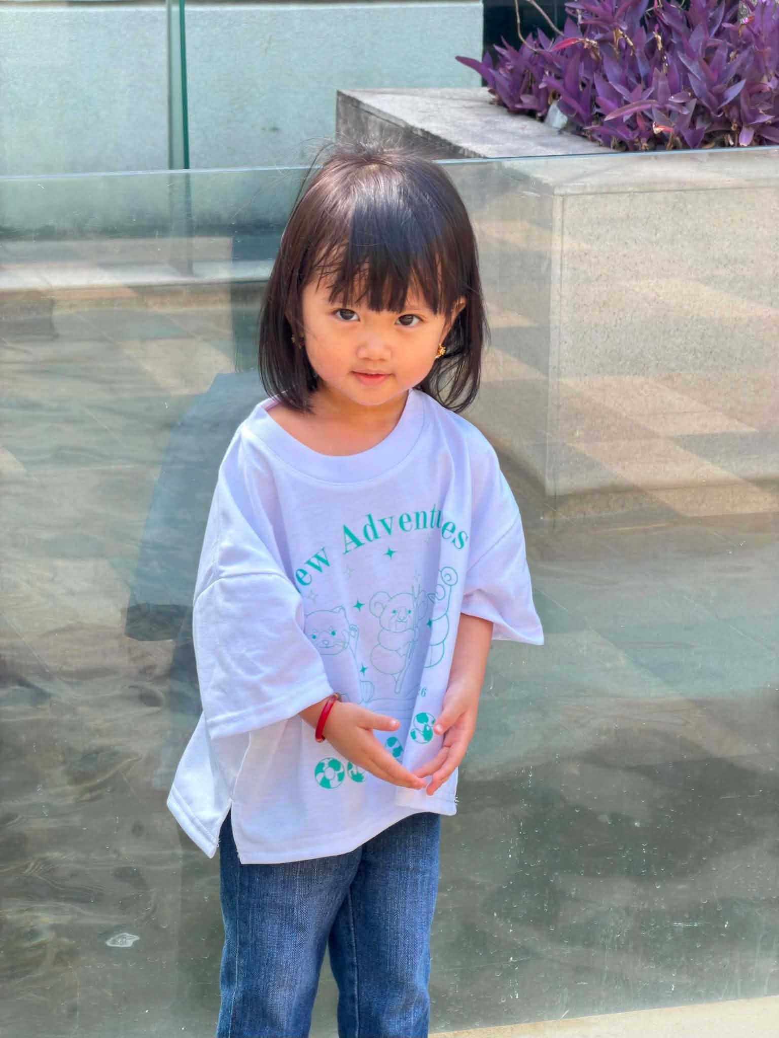 Ocean Kids model smiling in New Adventures Tee