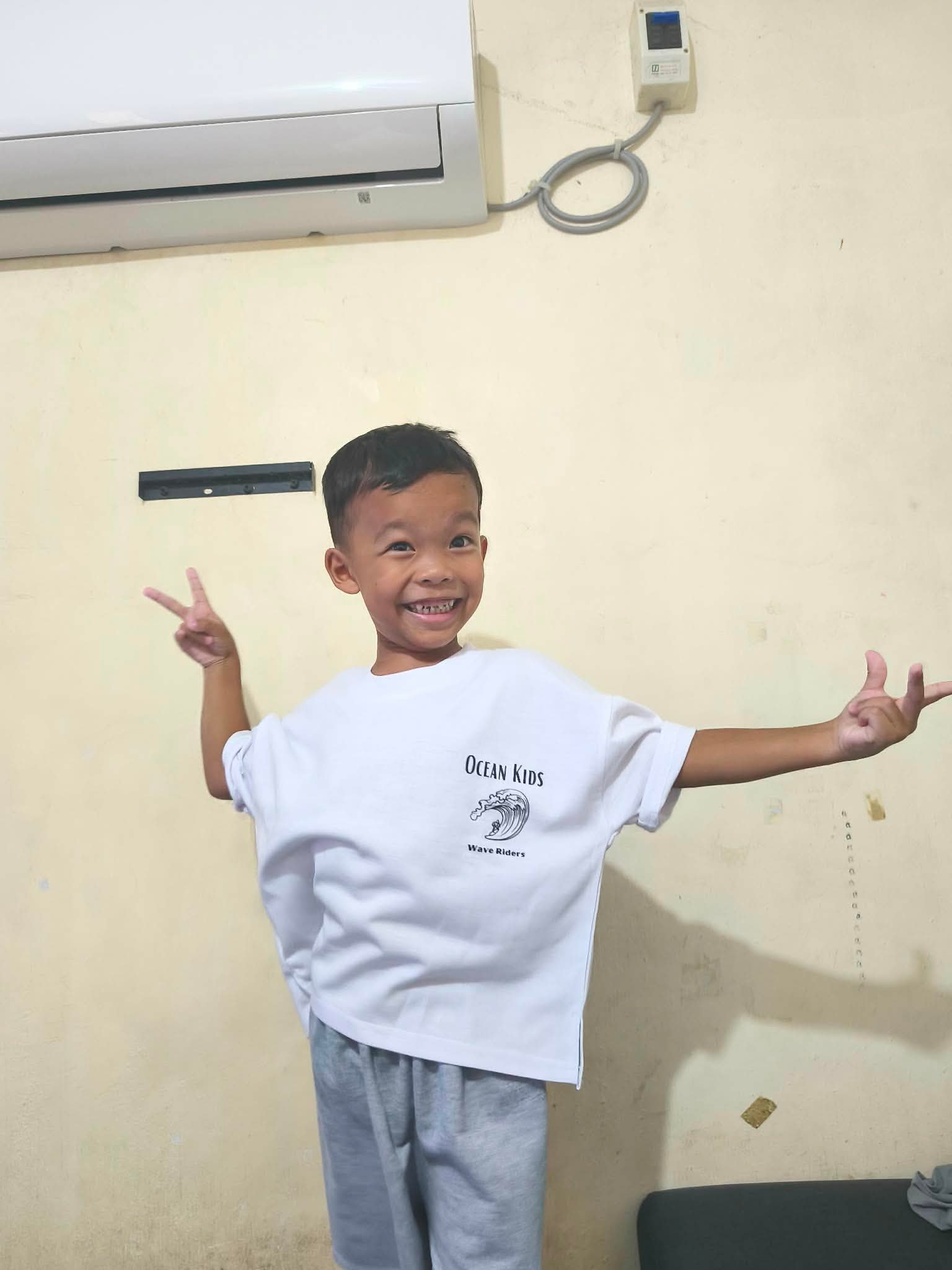 Child in Wave Riders Tee