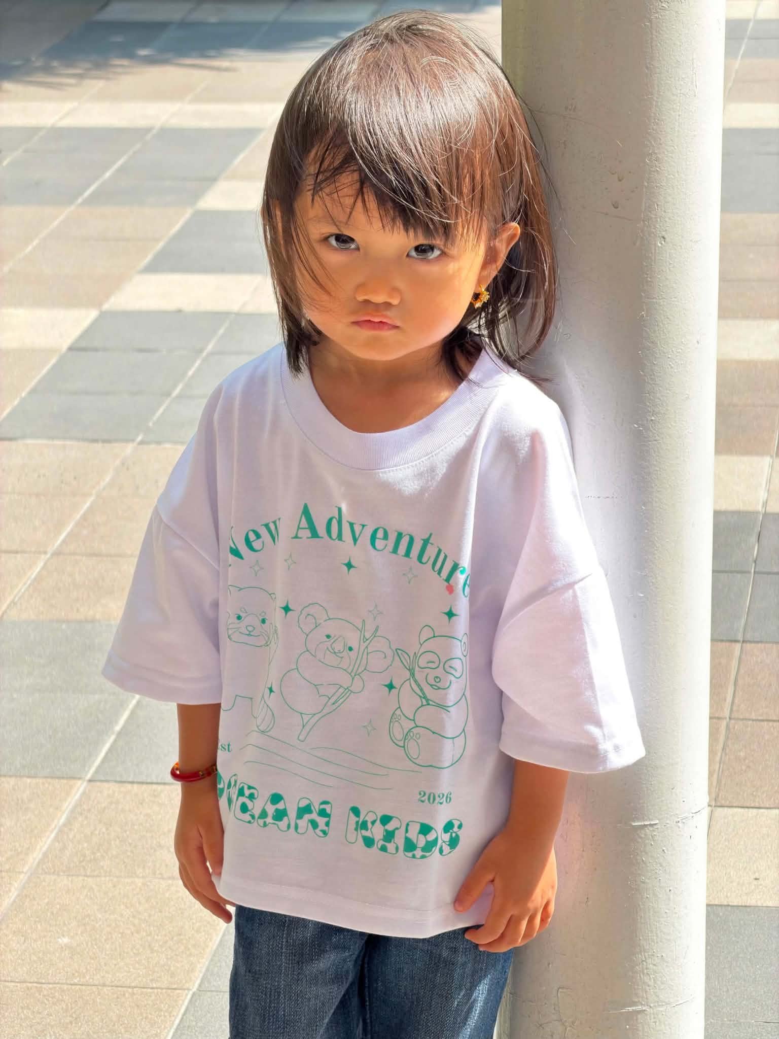 Ocean Kids model outdoors in New Adventures Tee